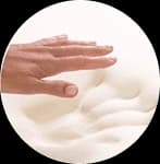 A hand resting on memory foam